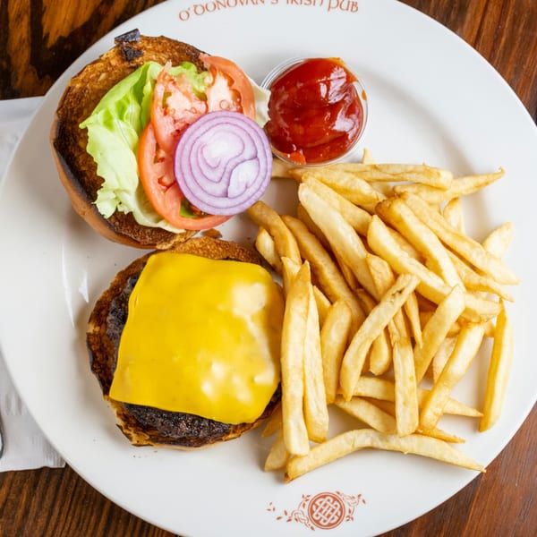 O'Donovan's Irish Pub cheeseburger with lettuce, tomato, onion, and a side of fries and ketchup.
